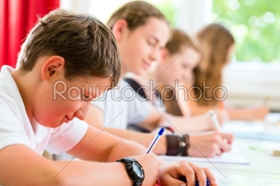 Students writing a test in school concentrating