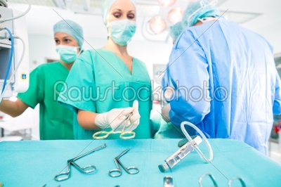 Surgeons operating patient in operating room 