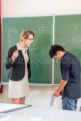 Teacher criticizing a pupil in school class