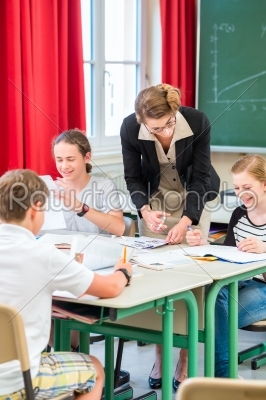 Teacher teaching students  geography lessons in school