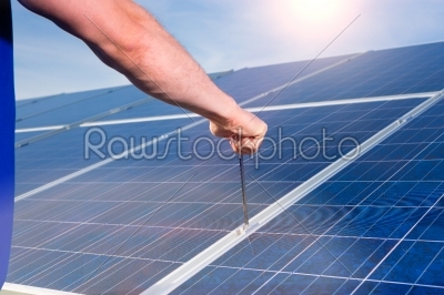 technician maintaining  solar panels 