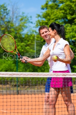 Tennis sport teacher teaching woman to play