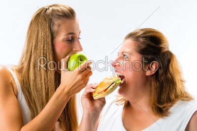 Thin and fat woman eating 