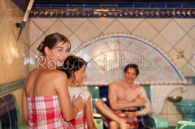 Three friends in sauna of a thermal bath