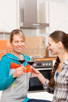 Two female friends moving in an apartment