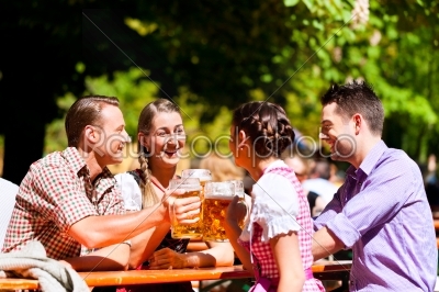 Two happy couples sitting in Beer garden