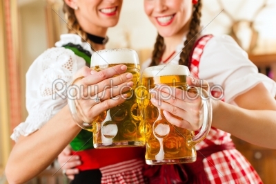 Two young women in traditional Bavarian Tracht in restaurant or pub