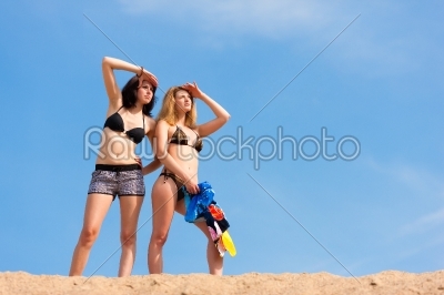 two young women with blue sky in summer