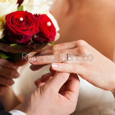 Wedding couple with bouquet and bridal ring