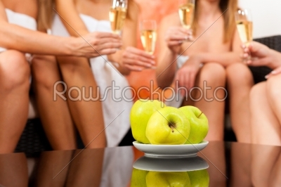Wellness - female friends drinking champagne in spa