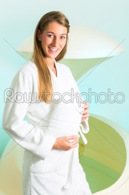 Wellness - young woman floating in Spa in Tank