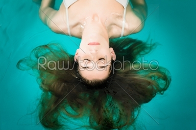 Wellness - young woman floating in Spa or swimming pool 