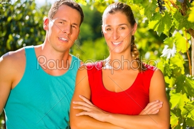 Woman and man standing in vineyard 