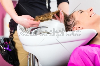 Woman at the hairdresser washing hair