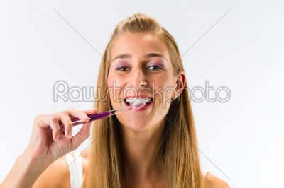 Woman brushing her teeth with toothbrush