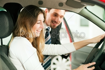 Woman buying car from salesperson