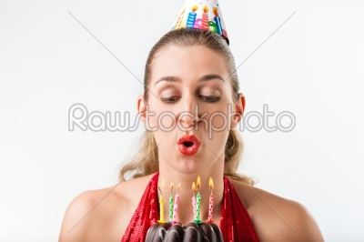Woman celebrating birthday with cake and candles