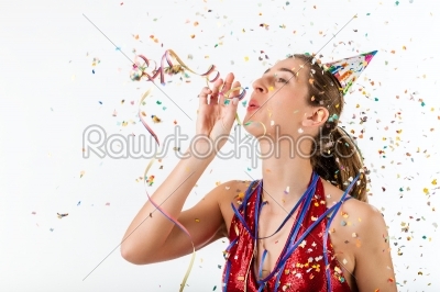 Woman celebrating birthday with streamer and party hat