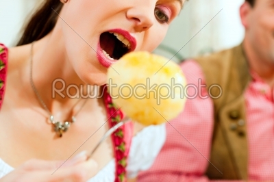 Woman eating dumplings in Bavarian restaurant