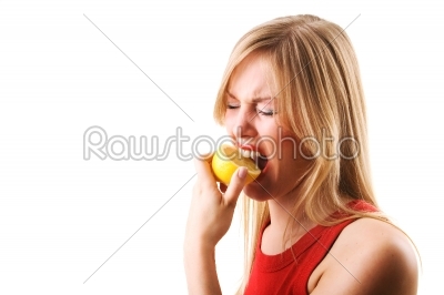 Woman eating lemon