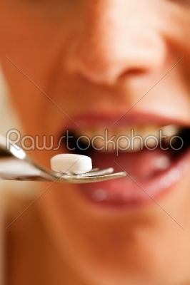 Woman eating nutritional supplements
