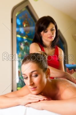 Woman enjoying massage in wellness spa
