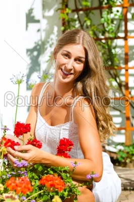 Woman gardener looking after flowers 