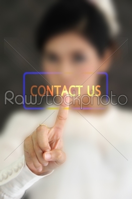 woman hand pressing contact us button on a touch screen 