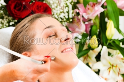 Woman in cosmetic salon receiving facial