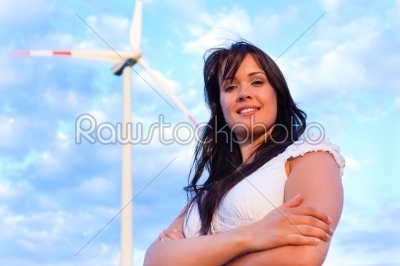 Woman in front of windmill and sky
