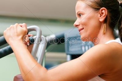 Woman in gym on machine
