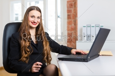 woman in office sitting on the computer