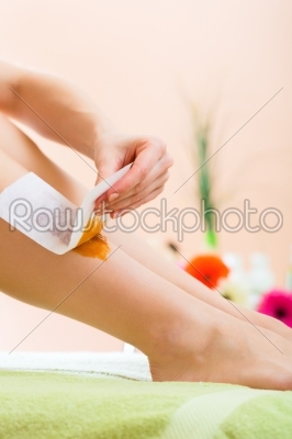 Woman in Spa getting leg waxed