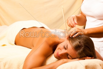Woman in therapy with ear candles