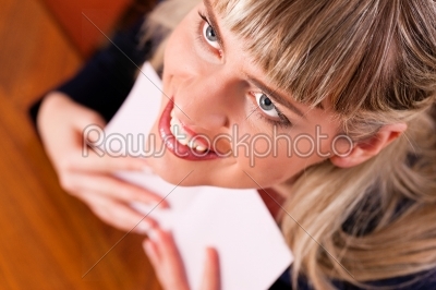 Woman is holding a letter