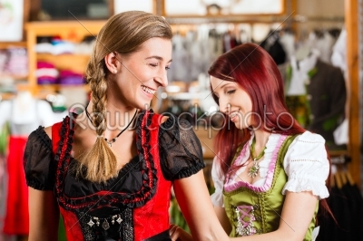 Woman is trying Tracht or dirndl in a shop