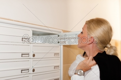 Woman looking after mail in letter box