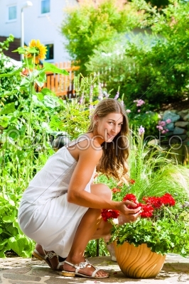 Woman looking at her flowers in the garden
