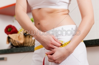Woman measuring her hip with tape