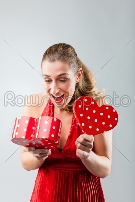 Woman opening the gift and is happy