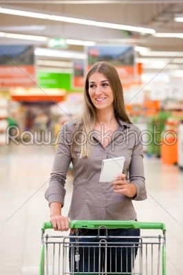 Woman Shopping with Checklist and Trolley