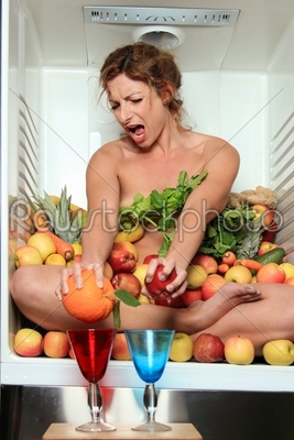 Woman sitting in a fridge