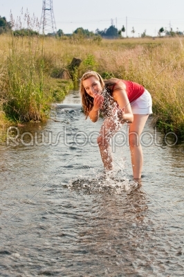 Woman standing in creek summer