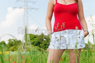 Woman standing in meadow or field