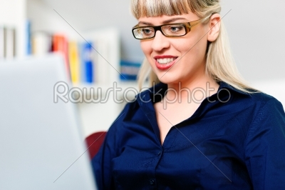 Woman telecommuting using laptop 