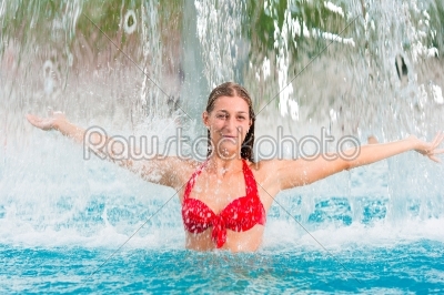 Woman under water gadget in swimming pool