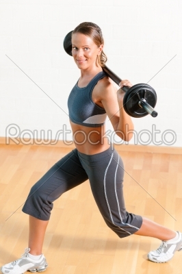 Woman with barbell in gym