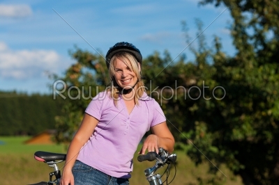 Woman with bicycle and helmet