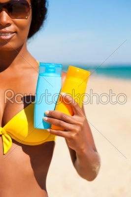 Woman with suncream at the beach
