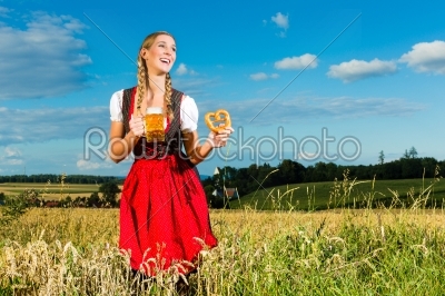 woman with tracht, beer and pretzel in Bavaria